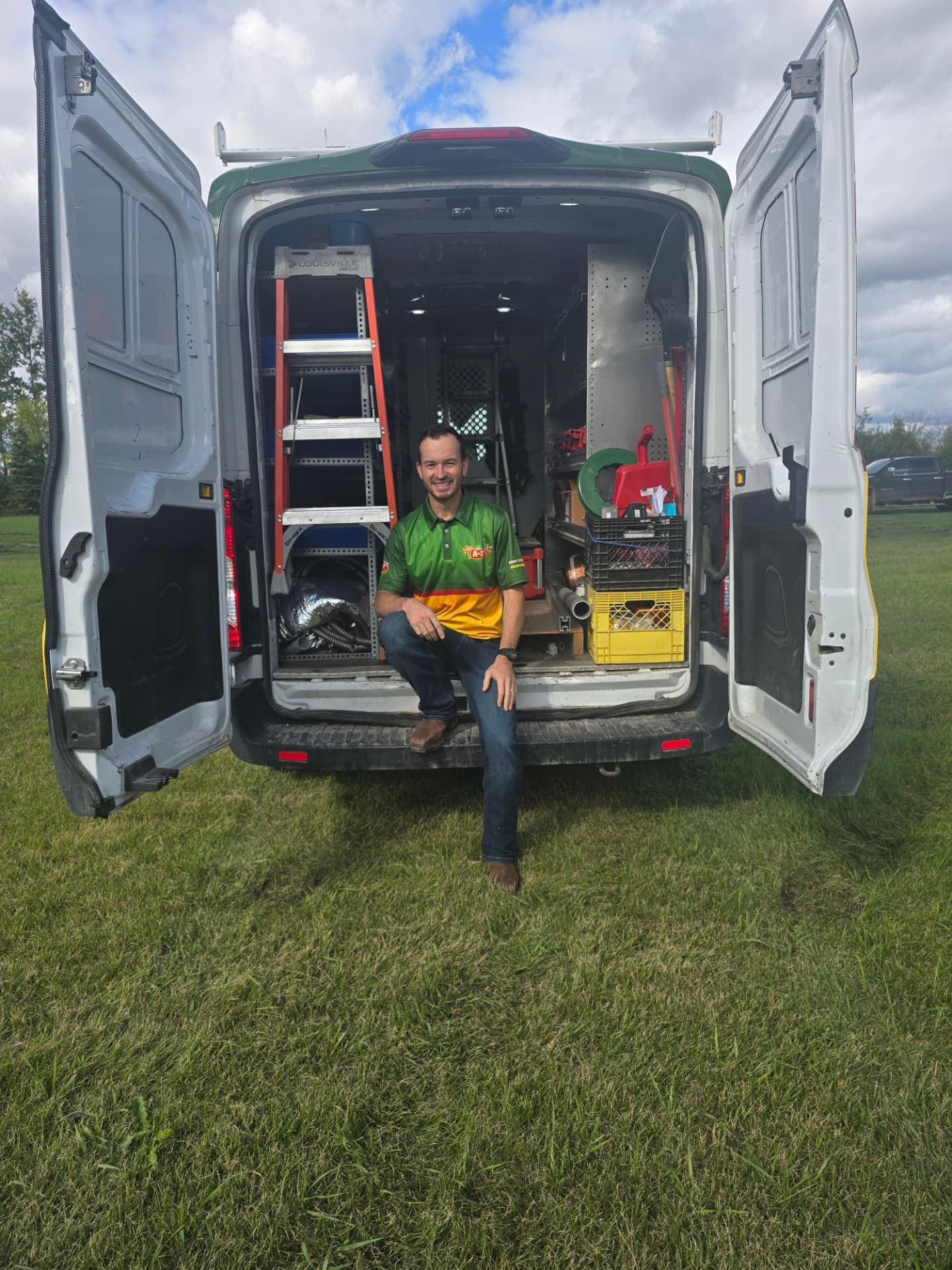 Adam, owner of A to Z, sitting in the back of the stocked A to Z service van